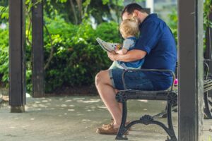 dad with read aloud books for babies